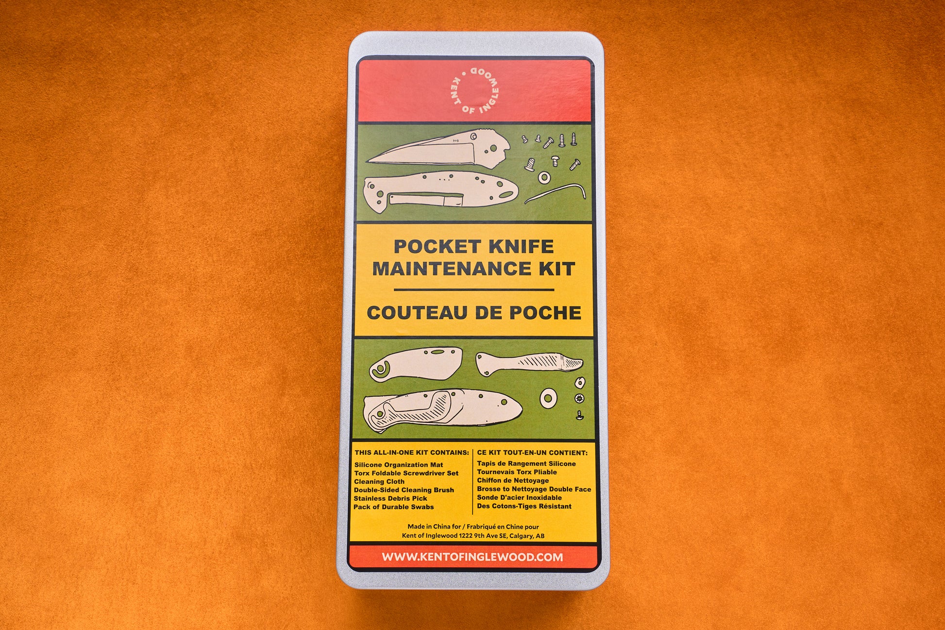 Rectangular tin labeled “Kent of Inglewood Pocket Knife Care Kit” featuring knife illustrations, bilingual English-French text, and information on included and excluded items—ideal for pocket knives and comes with detailing swabs—all set against an orange background.