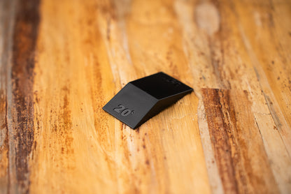Knifewear Sharpening Angle Guide, a black wedge with a 20° emboss, assists in achieving precise knife sharpening angles for diverse blades.