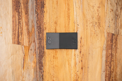 Knifewear Sharpening Angle Guide on wooden surface, featuring two hinged panels marked 15° and 20° for precise knife sharpening at correct angles.