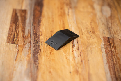 Knifewear Sharpening Angle Guide, a black wedge with a 15-degree emboss, ideal for achieving precise knife sharpening angles for Japanese blades.