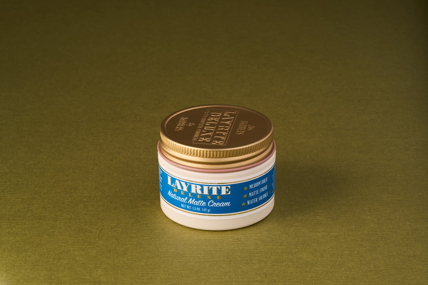 Layrite Natural Matte Cream jar with gold lid, labeled for medium hold and matte finish, ideal for natural styles.