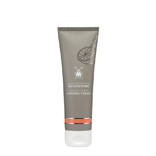 A tube of Mühle Grapefruit & Mint Shaving Cream featuring a gray body, white cap, and minimalist citrus and mint design on the front, formulated with natural essential oils for a nourishing shave.