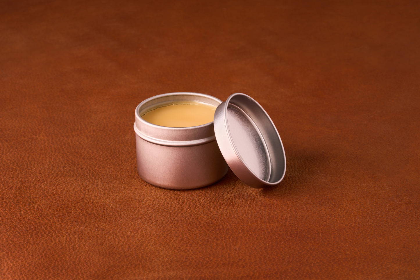 Mammoth Beard Co. Strong Hold Beard Balm Unscented 60ml tin open, revealing smooth balm on leather surface, ideal for moisturizing and shaping beards.