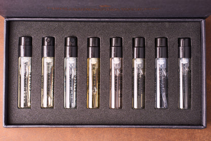The Mistral Eau de Parfum Discovery Set includes eight labeled sample vials with black spray tops, each containing a unique French men's fragrance, arranged in a sleek, foam-lined box.