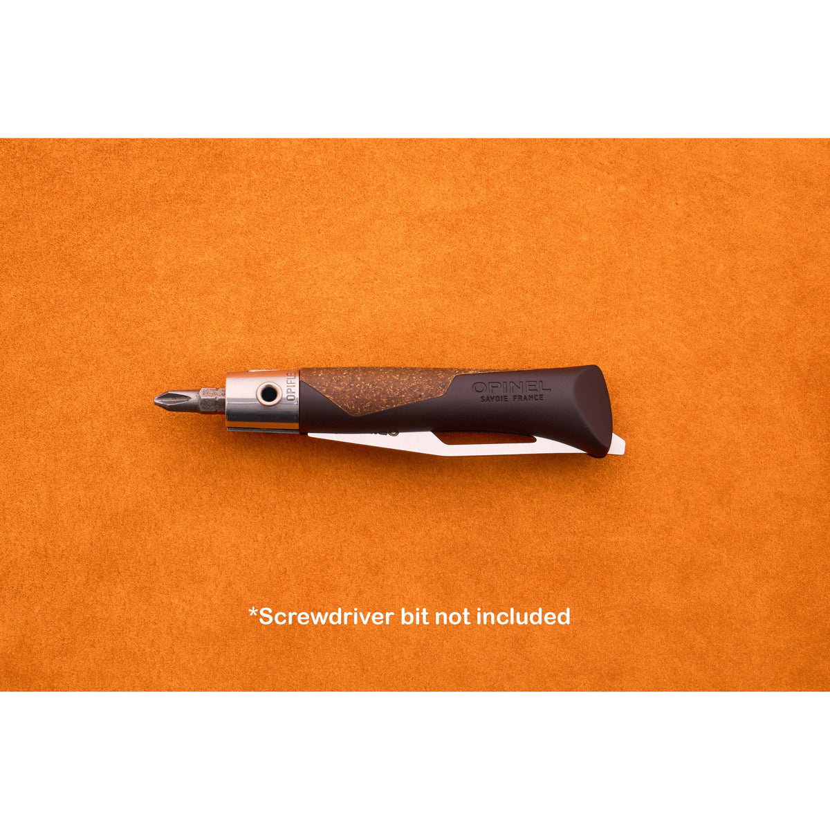 An Opinel Neo 7 Alpine with a black and brown handle and a metal collar is displayed on an orange surface, evoking the classic Opinel style. Text below states, *Screwdriver bit not included.*.