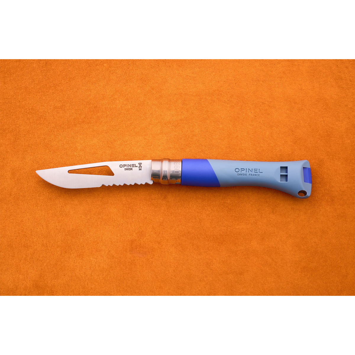 An Opinel No. 9 Ocean sailing knife, featuring a blue handle, partially serrated blade, thumb hole, and handy marlinespike, is displayed on an orange surface.