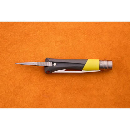 An Opinel No. 9 Ocean folding sailing knife, featuring a black and yellow handle and a partially open blade, rests on an orange textured surface.