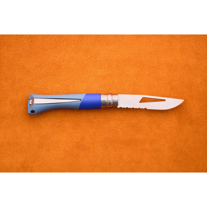 The Opinel No. 9 Ocean folding sailing knife, featuring a blue handle and a partially serrated blade, is displayed on an orange textured surface.