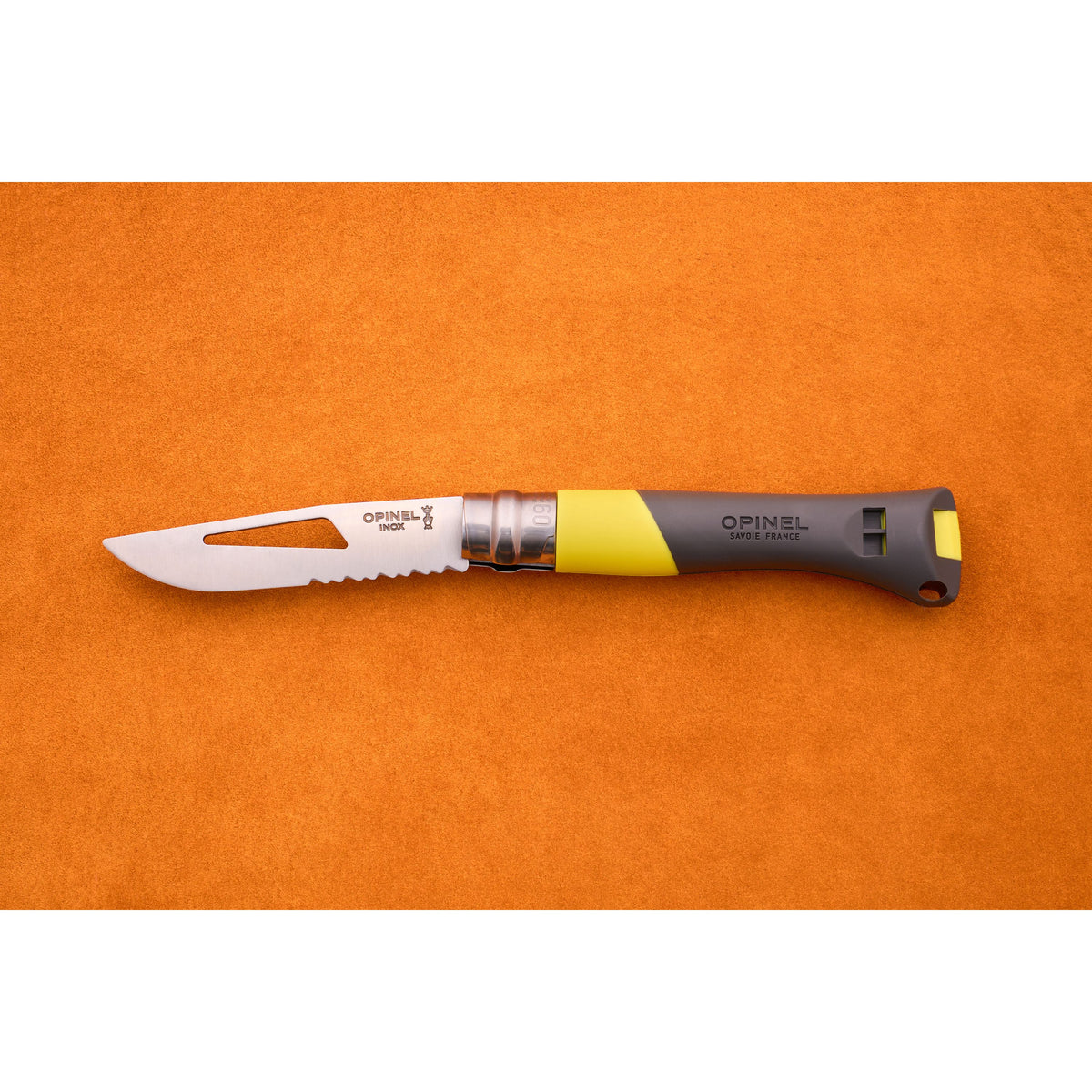 An Opinel No. 9 Ocean folding knife, featuring a partially serrated blade and a gray-yellow handle styled for sailing, is displayed on an orange surface.