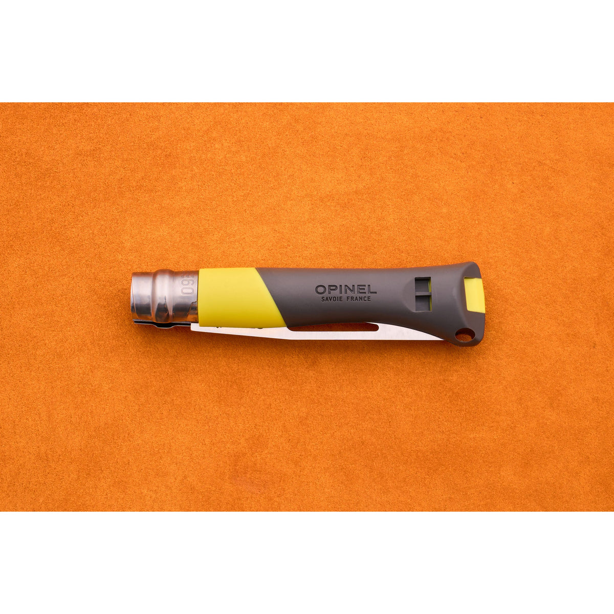An Opinel No. 9 Ocean sailing knife in gray and yellow, with a partially visible blade, rests on an orange textured surface.