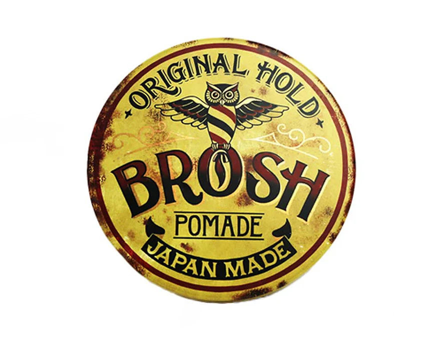 Round logo of BROSH Pomade with yellow background and black text
