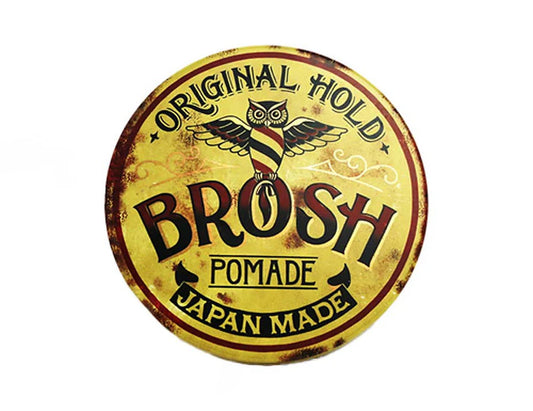 Round logo of BROSH Pomade with yellow background and black text