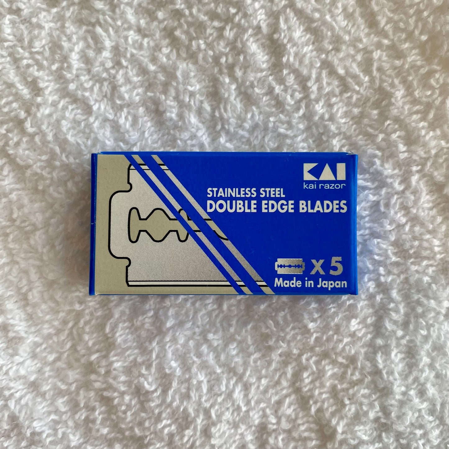 Nolan's All-In-One Shaving Kit includes a box of KAI stainless-steel double-edge razor blades, highlighted for a premium shaving experience.