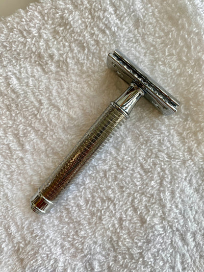 Nolan's All-In-One Shaving Kit, featuring a double-edge safety razor with knurled handle, elegantly positioned on a towel, epitomizing classic shaving craftsmanship.
