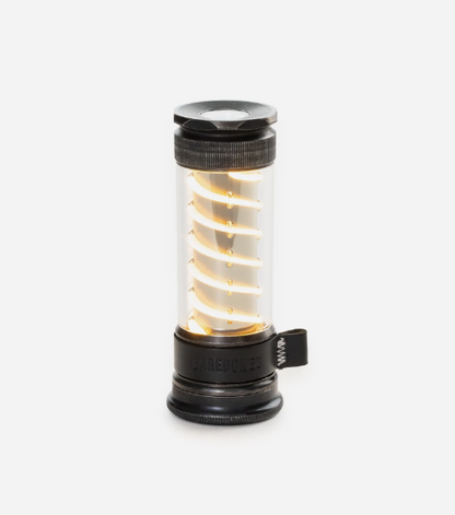 Barebones Edison Light Stick, a portable LED lantern with spiral filament design, ideal for camping. Features USB charging and dual functionality as an outdoor lantern and emergency flashlight.