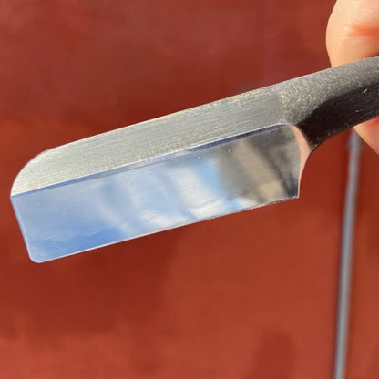 Takami Kamisori Japanese Straight Razor Western Grind; a metal blade with a polished, razor-sharp bevel, exemplifying traditional craftsmanship and modern ergonomics.