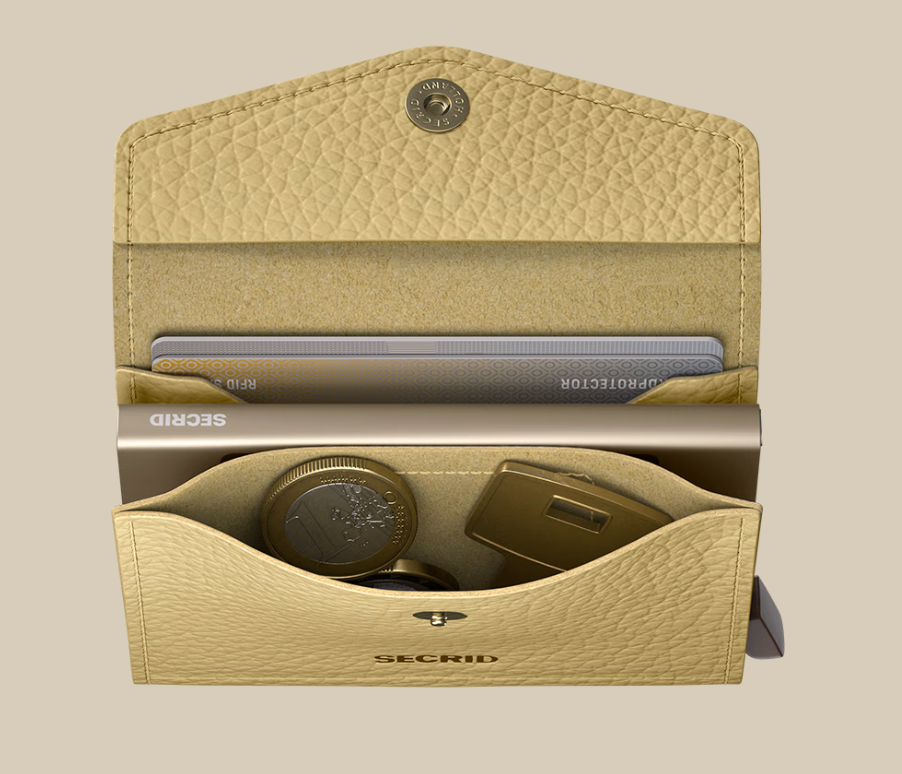 A beige Secrid Envelope Wallet made of leather is open, showing cards, coins, and a gold USB drive organized inside. This stylish RFID-blocking wallet is displayed against a neutral background.