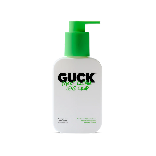 Bottle of GUCK shaving cream with green pump on a white background