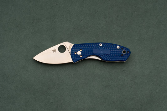 Spyderco Ambitious Blue Lightweight CPM folding pocket knife for daily-carry, featuring a satin-finished drop-point blade and a textured blue handle with one-handed opening.
