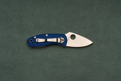 A textured blue handle and stainless steel blade define the Spyderco Ambitious Blue Lightweight CPM folding pocket knife, designed for one-handed opening as a reliable daily-carry tool.