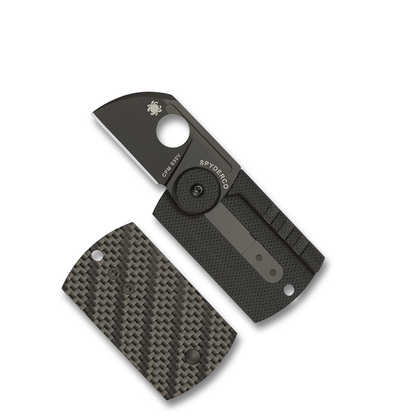 A Spyderco Dog Tag Folder Carbon Fibre featuring a partial blade and a matching carbon fiber dog tag-style cover.