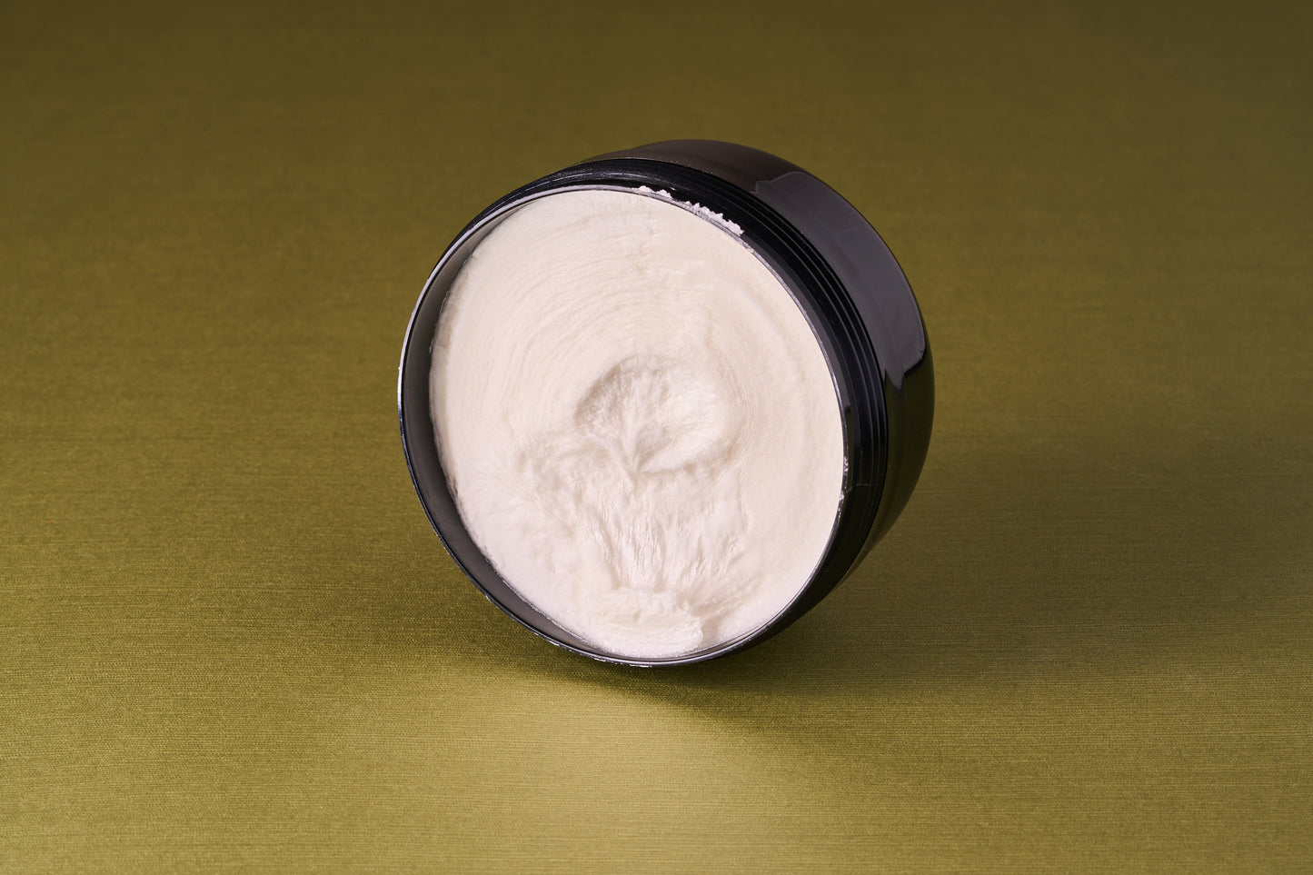 Taylor of Old Bond Street Royal Forest Shaving Cream in a black jar, showcasing a smooth, off-white cream, ideal for a refreshing, classic shave.