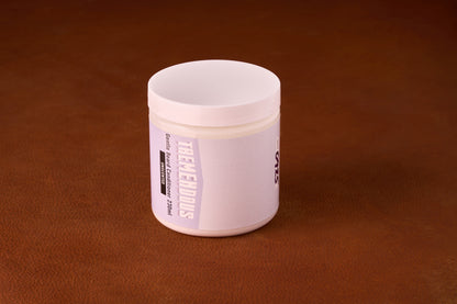TREMENDOUS Gentle Beard Conditioner, 230 ml, unscented jar on a brown surface, promotes silky, voluminous beard care with natural ingredients, ideal for daily grooming.