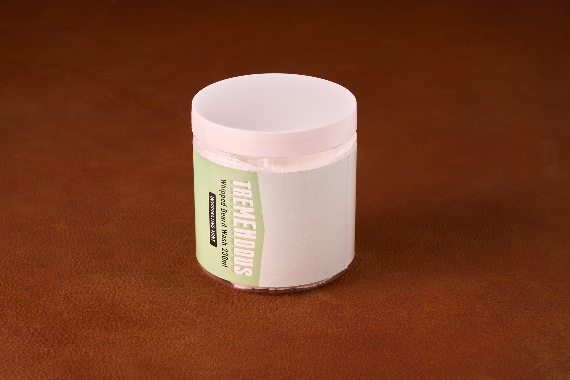 Tremendous PH Balanced Whipped Beard Wash in a clear jar with a white lid, offering gentle, mint-scented cleansing for sensitive skin and beards.