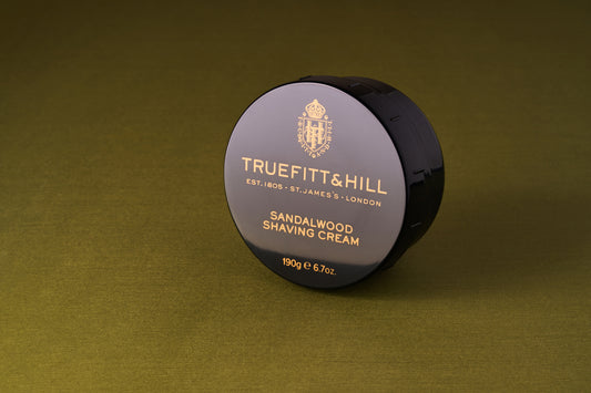 Truefitt & Hill Sandalwood Shave Cream tub on fabric, highlighting its Victorian-era tradition and rich lather, ideal for a premium shaving experience.