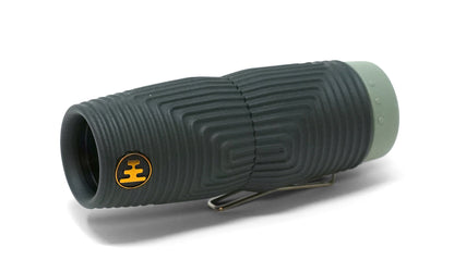 A compact NOCS Provisions Zero Tube 10x25 Monocular with a textured black and gray finish and a gold-and-black logo on the side, shown from a slight angle against a white background.