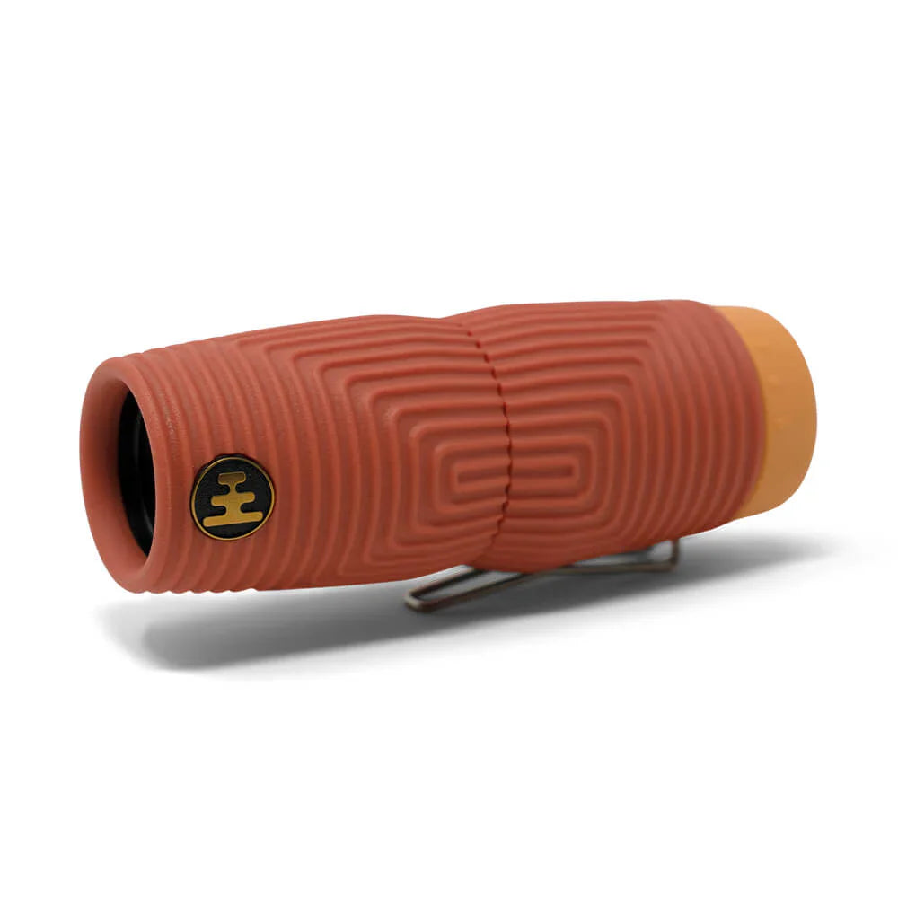 NOCS Provisions Zero Tube 10x25 Monocular with orange/red ribbed rubber body, yellow tail cap, and metal side clip, designed for rugged outdoor adventures.