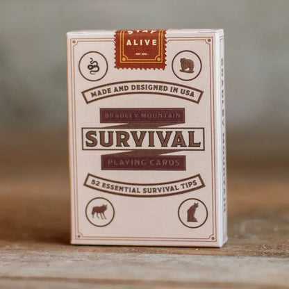 Boxed deck of Bradley Mountain Survival Playing Cards featuring wildlife icons and 52 essential survival tips, designed to inspire outdoor adventure.