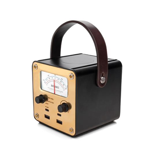 Black and gold portable radio with leather handle on a white background