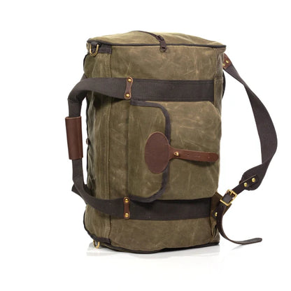 Frost River Explorer Duffel ESB No. 713: Medium-sized olive-green waxed canvas travel bag with leather accents, brass hardware, and versatile backstraps for easy carrying.