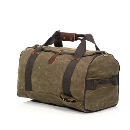 Frost River Explorer Duffel ESB No. 713: A medium-sized, olive-green waxed canvas bag with leather accents, brass hardware, and versatile backstraps, perfect for travel.