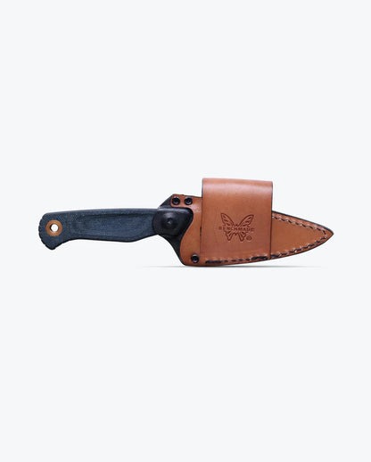 The Benchmade Dacian - Blue Denim Micarta fixed-blade knife, featuring a durable blue denim micarta handle, is partially sheathed in a brown scout-carry leather sheath embossed with the butterfly logo and displayed against a plain light background.
