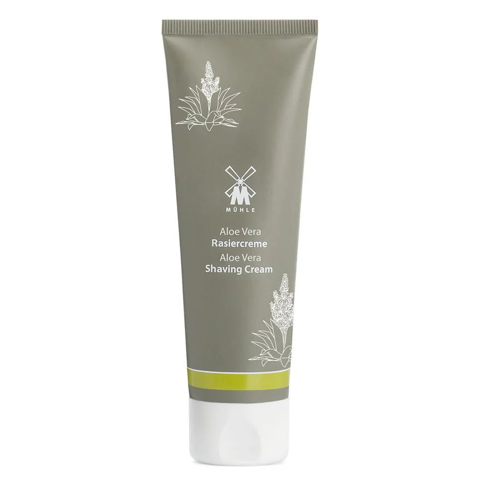 A gray tube of Mühle Aloe Vera Shaving Cream, featuring white graphics of an aloe plant and a windmill, designed specifically for sensitive skin and finished with a white cap at the bottom.