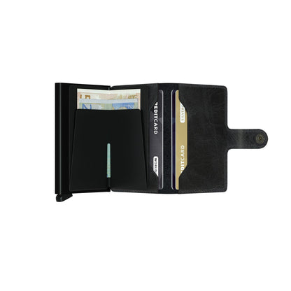 Secrid Wallets Miniwallet - Vintage: Open black wallet with a hard-shell card carrier and leather section, holding cards and cash, featuring a secure snap-closure strap.