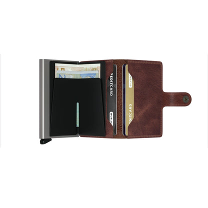 Secrid Wallets Miniwallet - Vintage with snap-closure flap and metal card-holder, displaying cards and euro banknotes for secure, stylish storage.