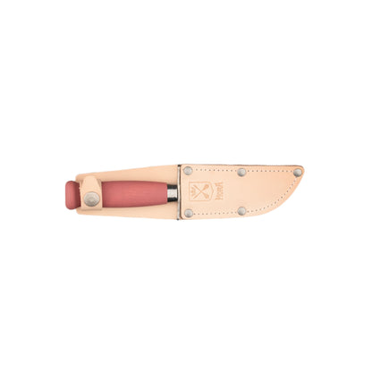 Mora Scout Camping Knife with a reddish wooden handle, resting in a tan leather sheath embossed with MORA, designed for safe outdoor use and skill teaching.