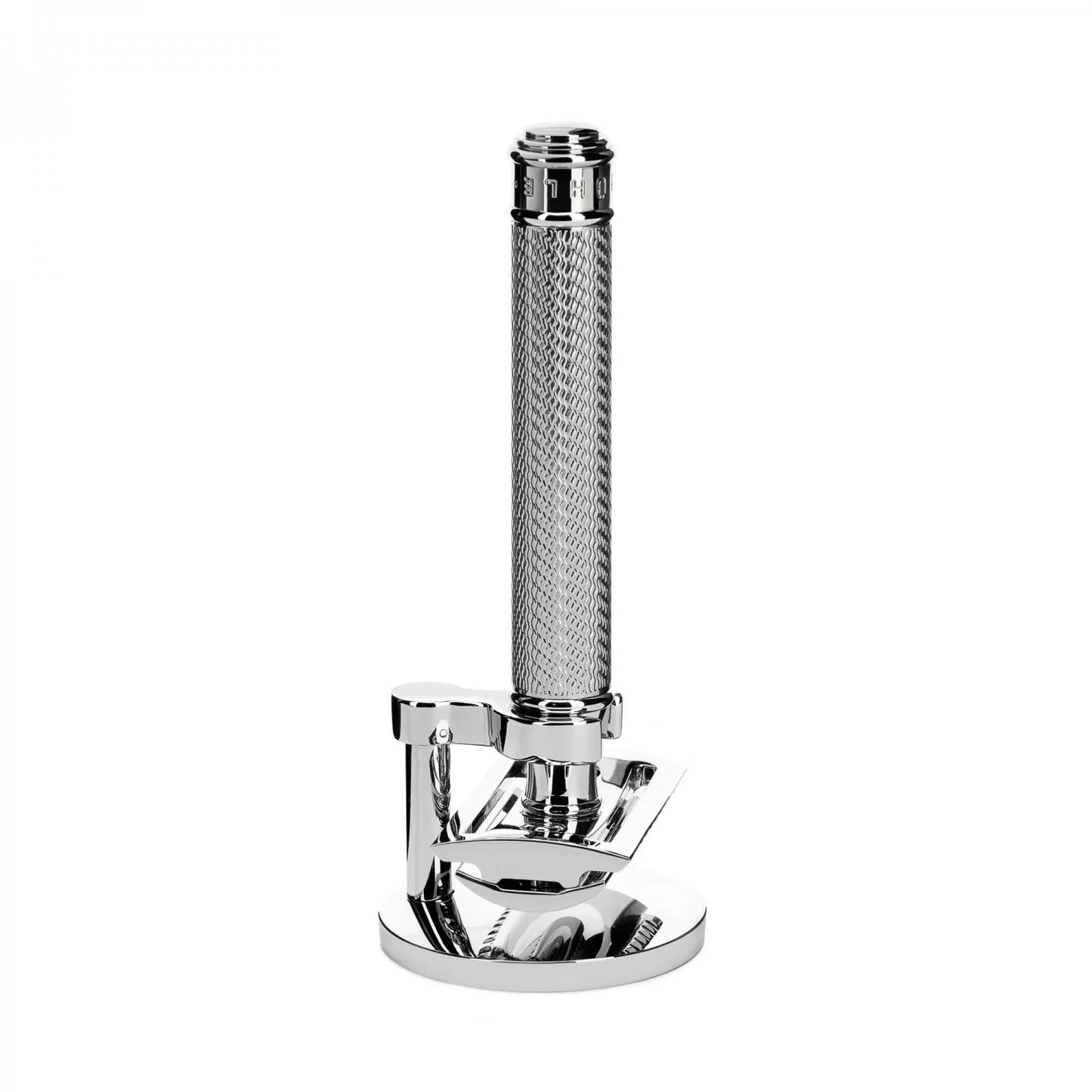 The Mühle Traditional 2pc. Shaving Set showcases a chrome razor standing upright on its coordinating stand, displaying a textured handle and a gleaming, reflective finish, all set against a white background.