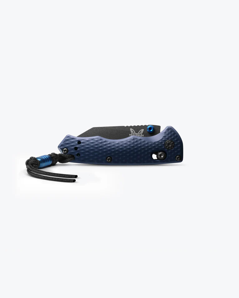 A closed Benchmade Full Immunity folding pocket knife with a blue finish, featuring a black textured grip and a black lanyard attached to the handle, displayed against a plain white background.