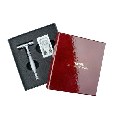 Feather AS-D2 Stainless Steel DE Safety Razor in a foam-lined case with replacement blades, showcasing Japanese engineering for a smooth, gentle shave.