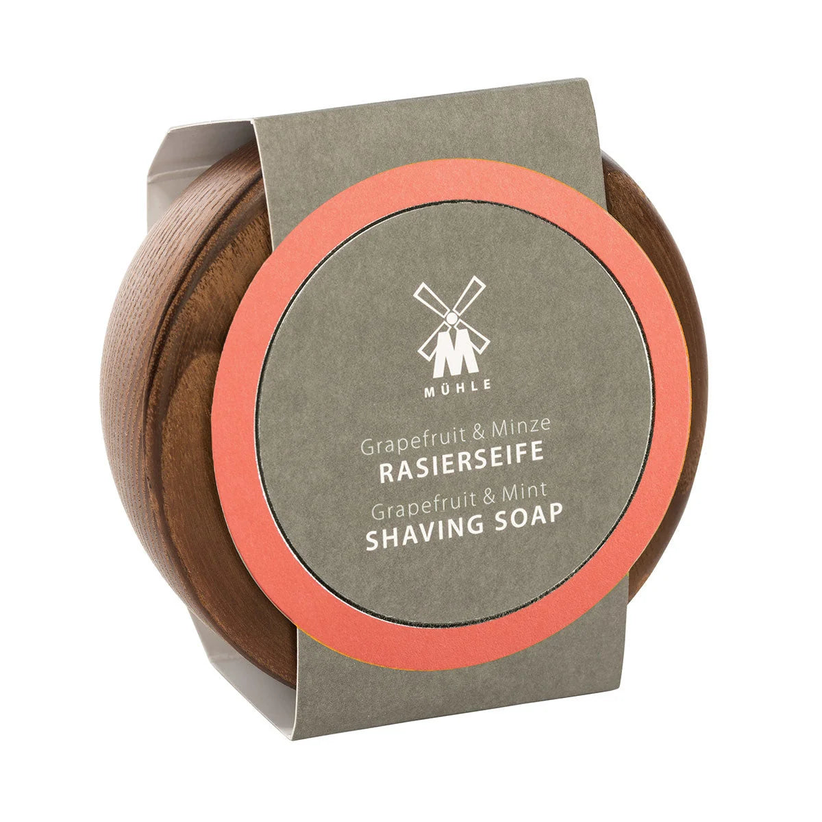 A round wooden container with a gray and orange label displays the product name “Mühle Grapefruit & Mint Shaving Soap” in both English and German. This vegan shaving soap offers a refreshing blend of grapefruit and mint scents, while the lid is adorned with Mühle’s signature windmill logo.