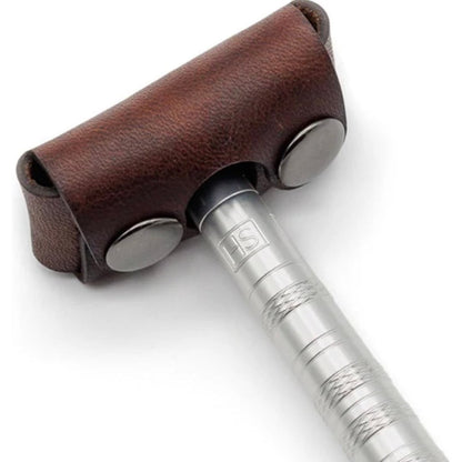 Close-up of the Henson Razor Head Cover, a brown leather travel cap with snap-buttons, fitting over the razor head, showcasing the knurled metal handle.