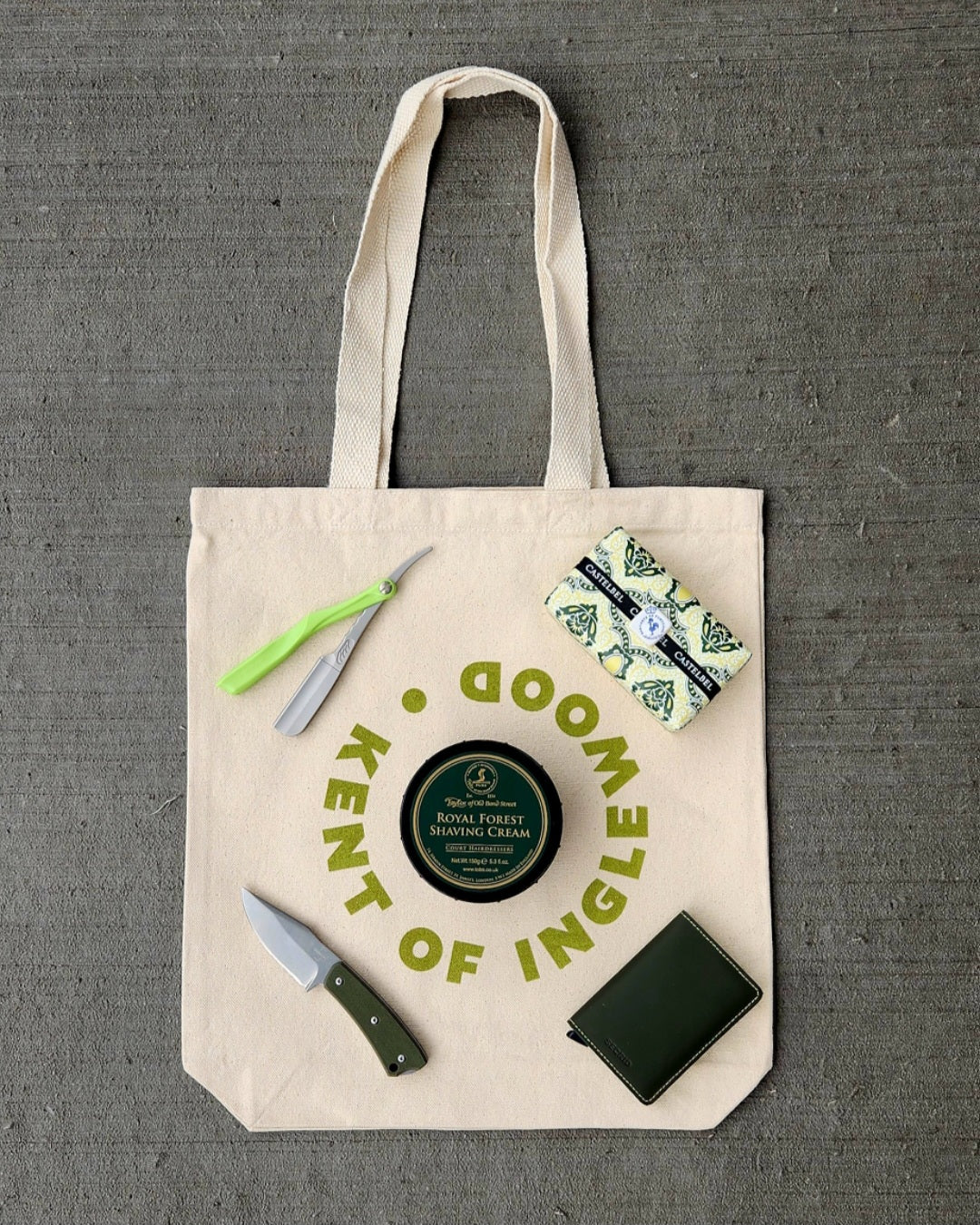 Kent of Inglewood Canvas Tote with everyday-carry shaving essentials: Taylor of Old Bond Street shaving cream, straight razor, pocket knife, leather wallet, and Castelbel item.