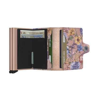 Secrid Wallets Twinwallet, featuring a sparkly floral print flap, holds 10-12 cards, cash, and more. Includes rose-gold RFID compartment for secure card storage.