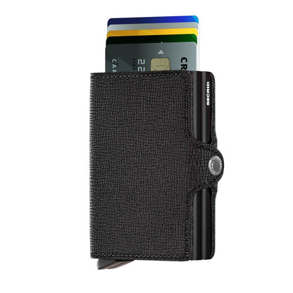 Secrid Wallets Twinwallet: A compact black leather wallet with RFID protection, featuring a sleek metal Cardprotector and lever for quick card access, handmade in Holland.