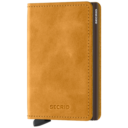Secrid Slimwallet - Vintage: A sleek, mustard leather wallet with a metal card sleeve and signature lever for easy card access, ideal for stylish, secure use.