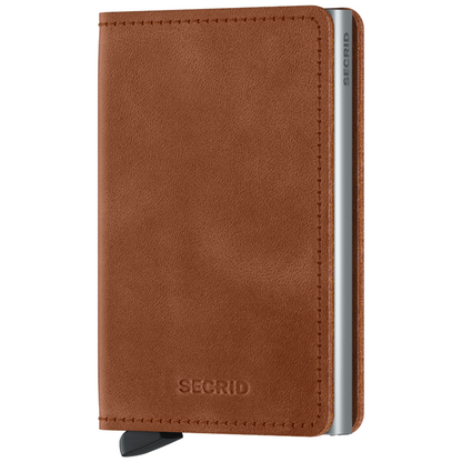 Secrid Wallets Slimwallet - Vintage features a cognac-brown leather cover, embossed logo, and silver aluminum card protector with a black tab for easy access.